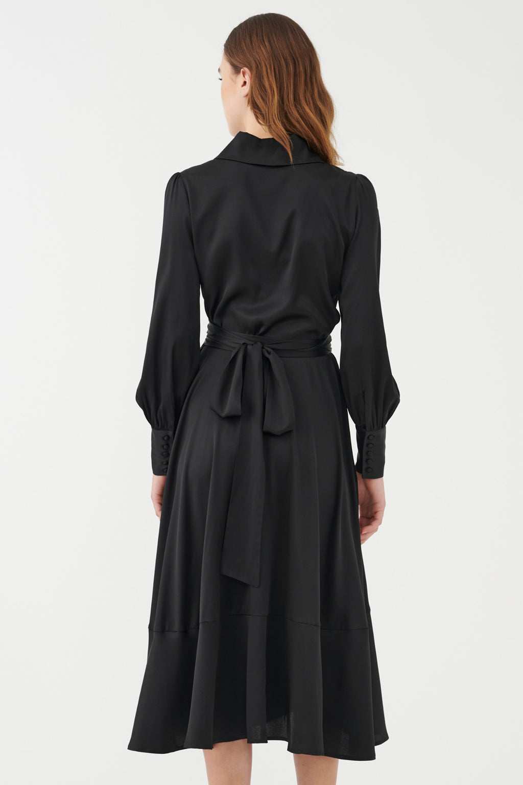 Black dress with a belt worn by a model on a white background