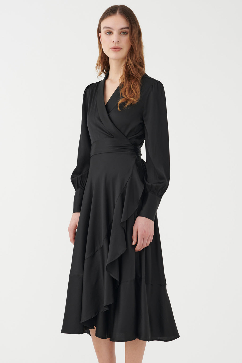 Woman wearing a black dress against a white background