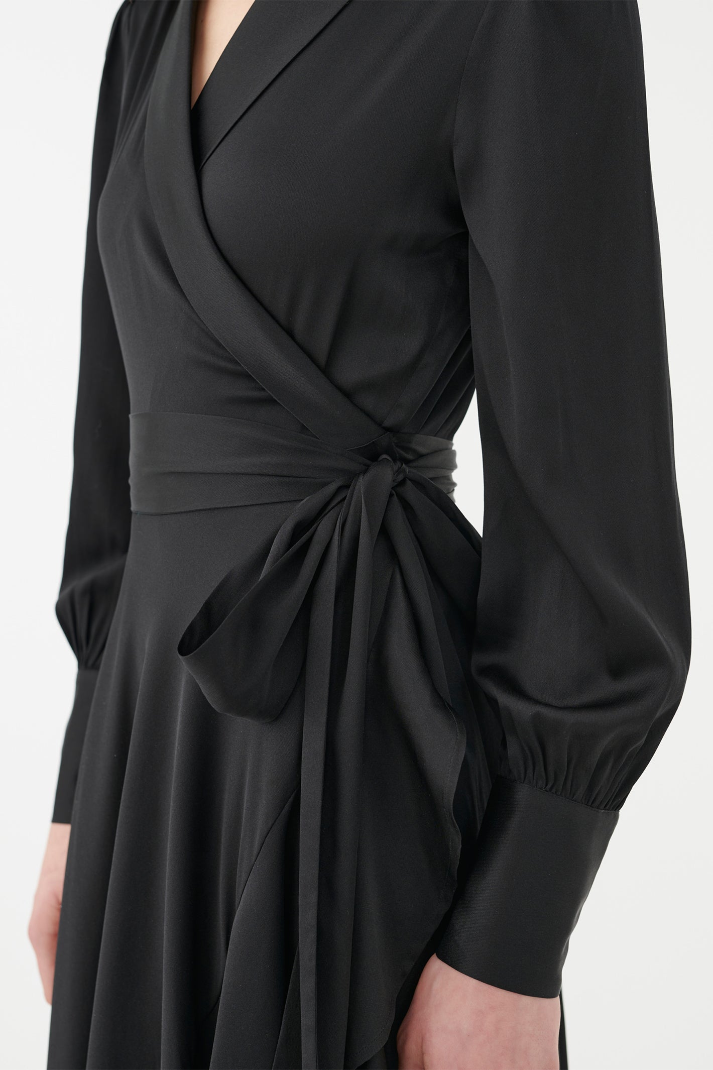 Black wrap dress with long sleeves on a white background