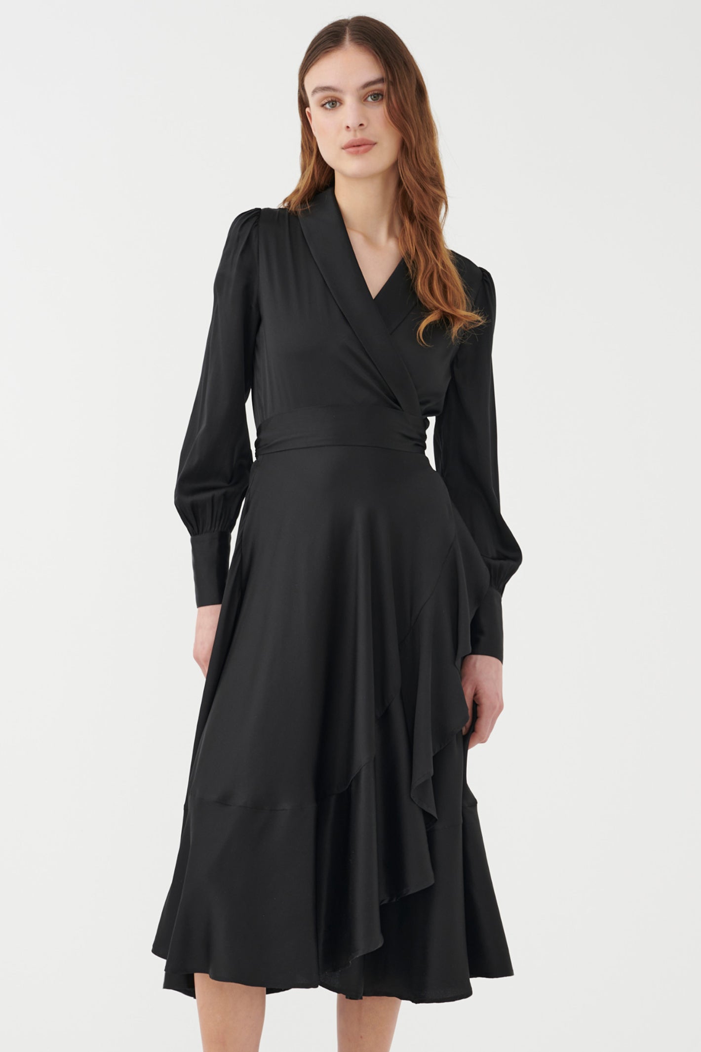 Woman wearing a black wrap dress on a white background