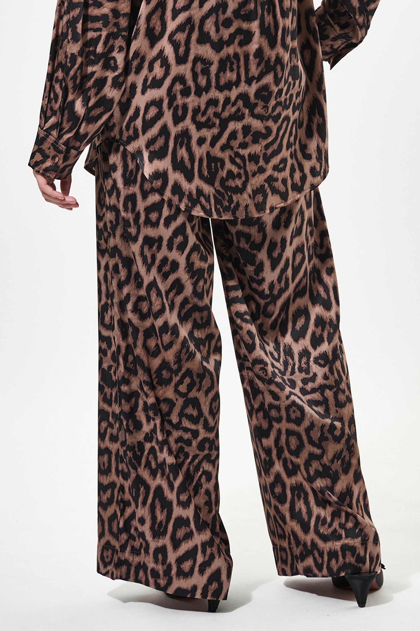 Leopard print outfit with a top and pants on a white background