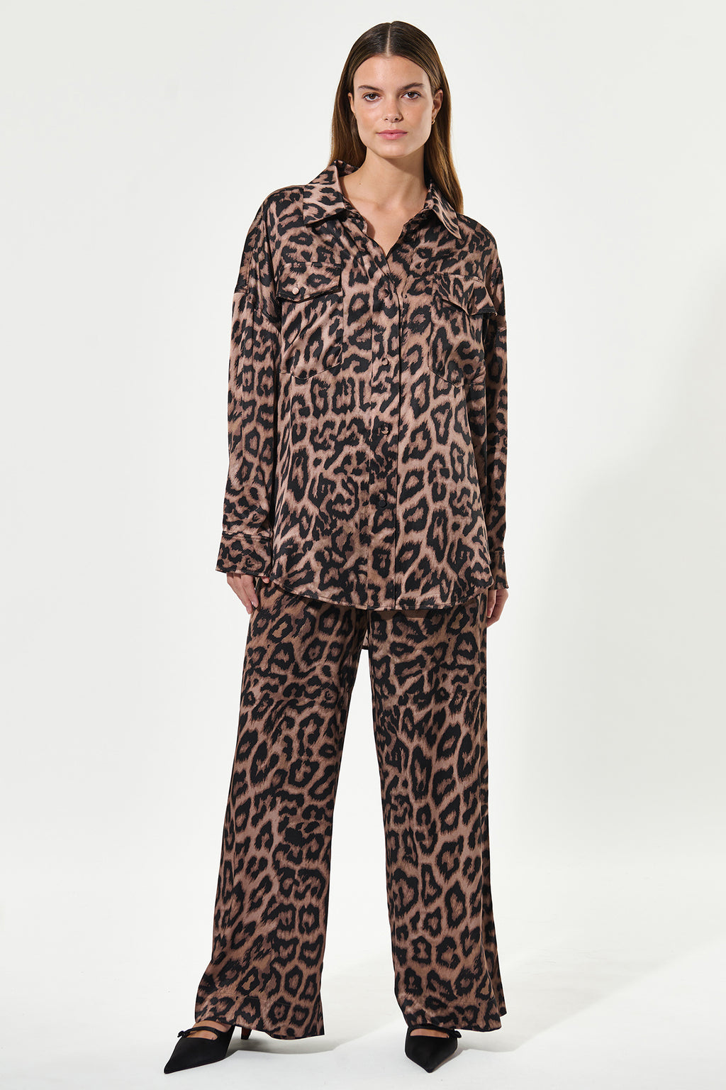 Woman wearing a leopard print outfit on a white background