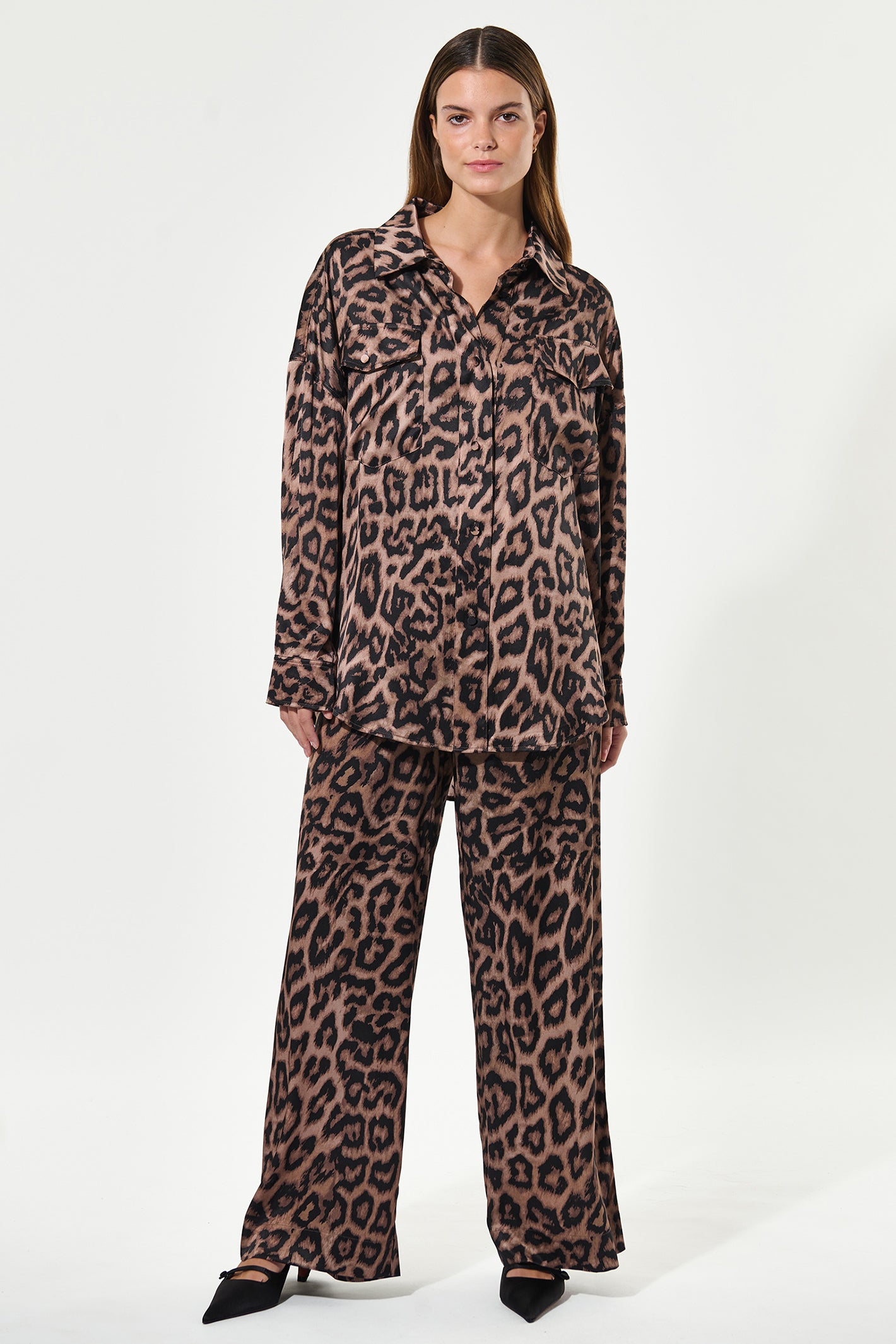 Woman wearing a leopard print outfit on a white background