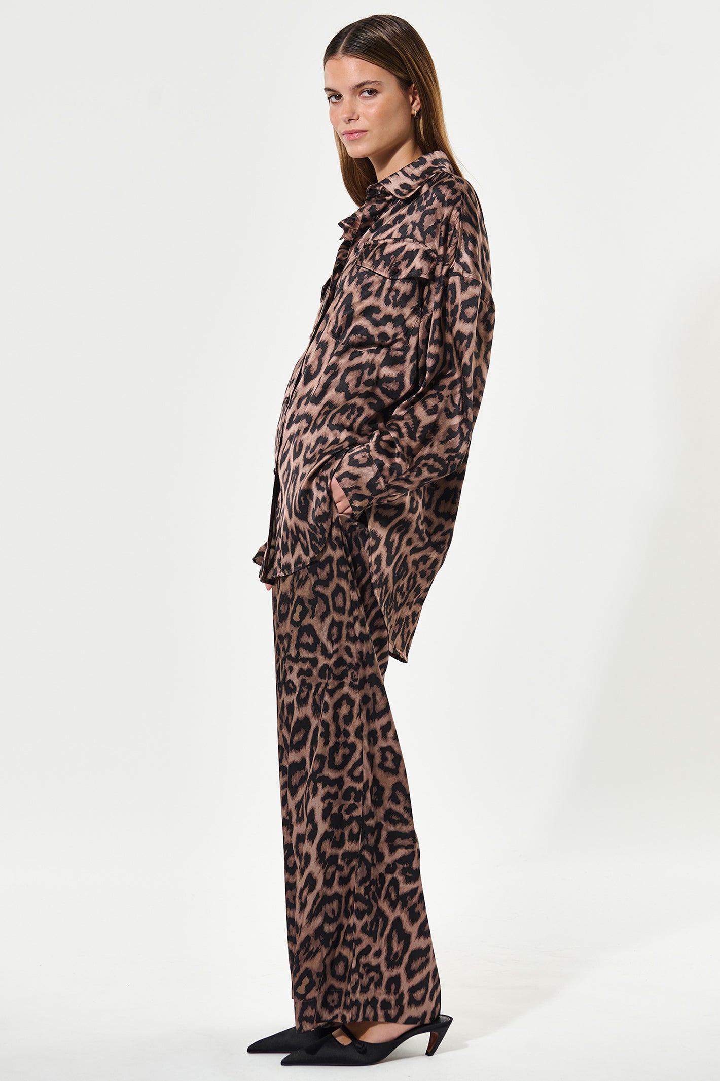 Woman wearing a leopard print outfit on a white background