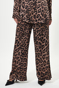 Leopard print pants worn by a person on a white background
