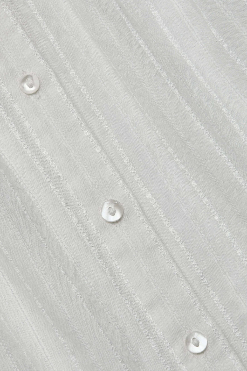 Close-up of a textured gray fabric with button details
