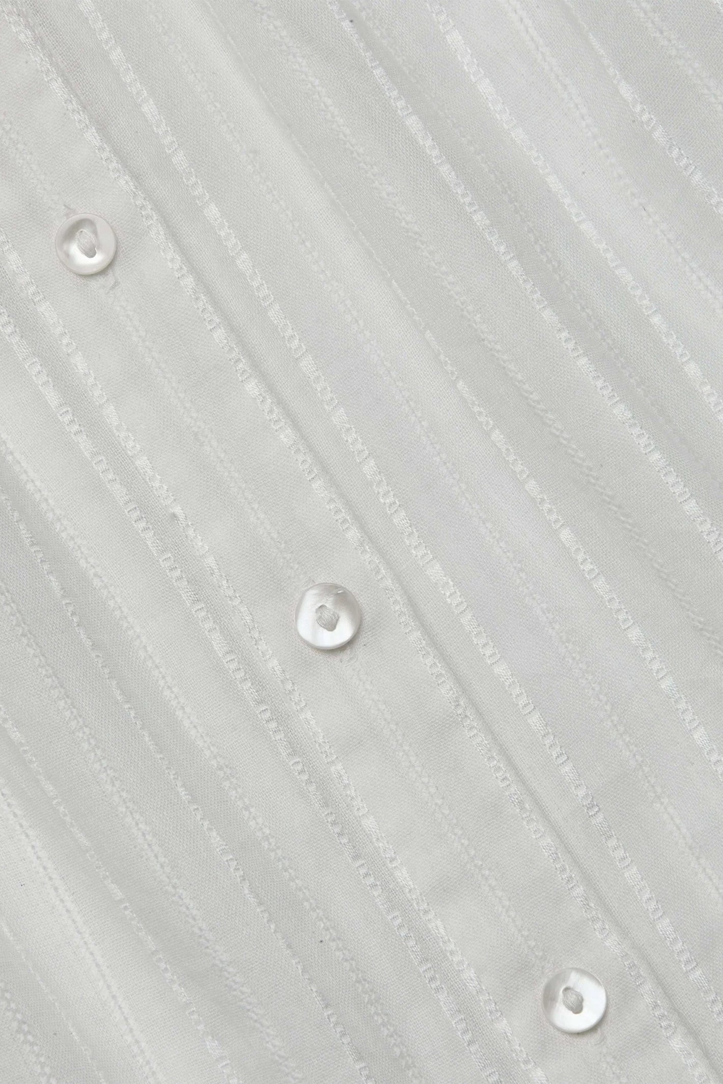 Close-up of a textured gray fabric with button details