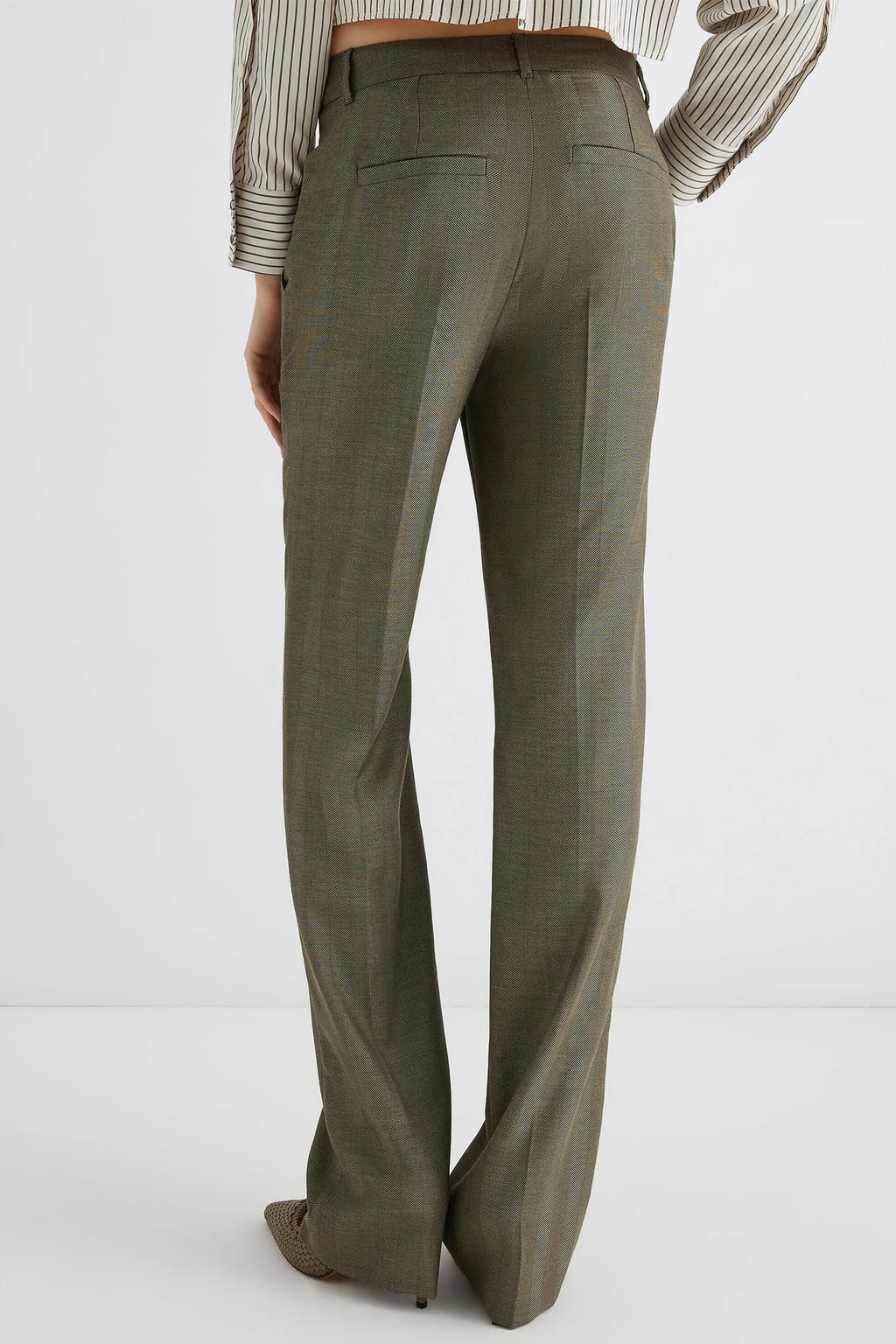 Green pants worn by a person on a white background
