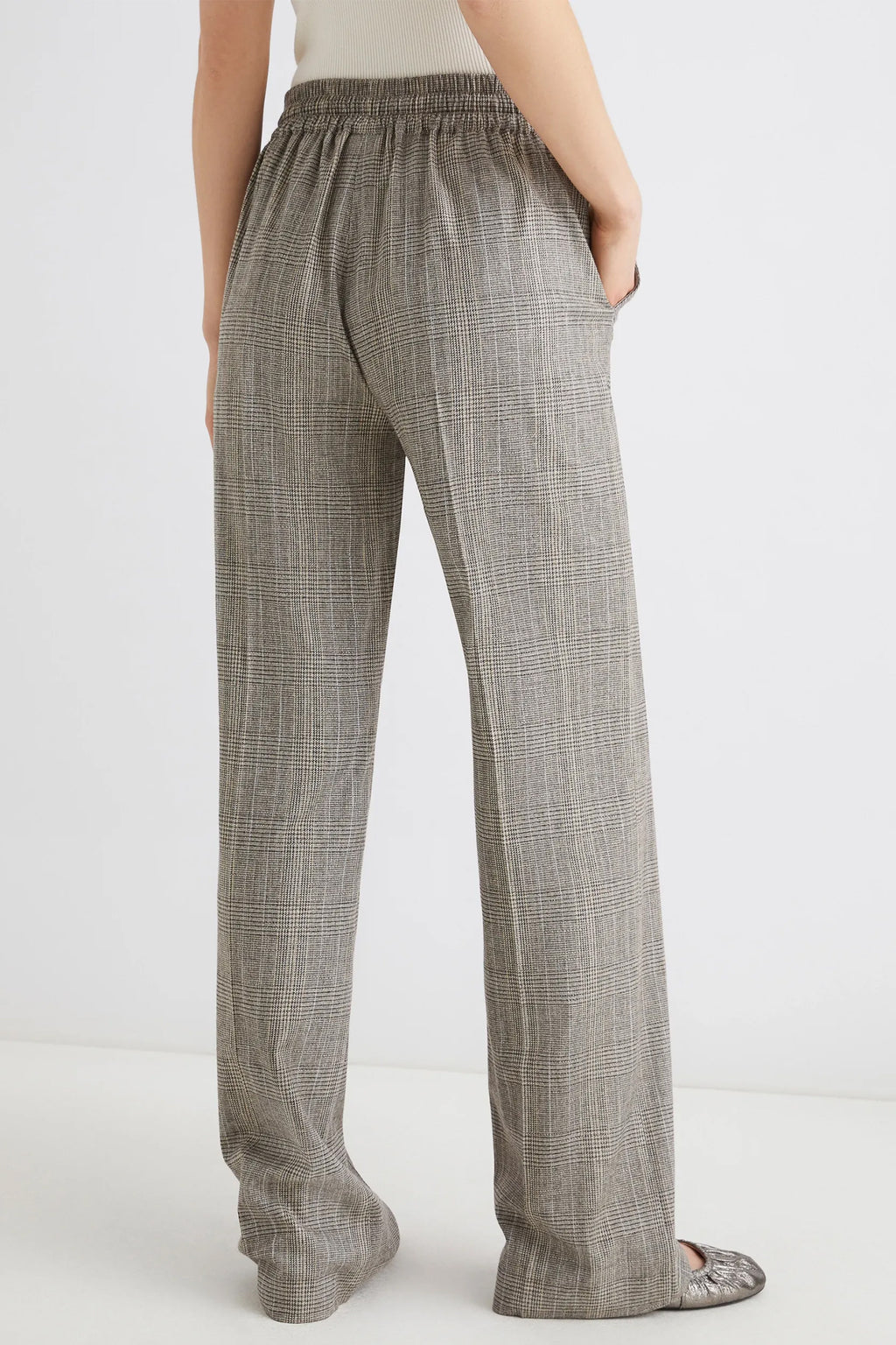 Plaid pants worn by a person on a white background
