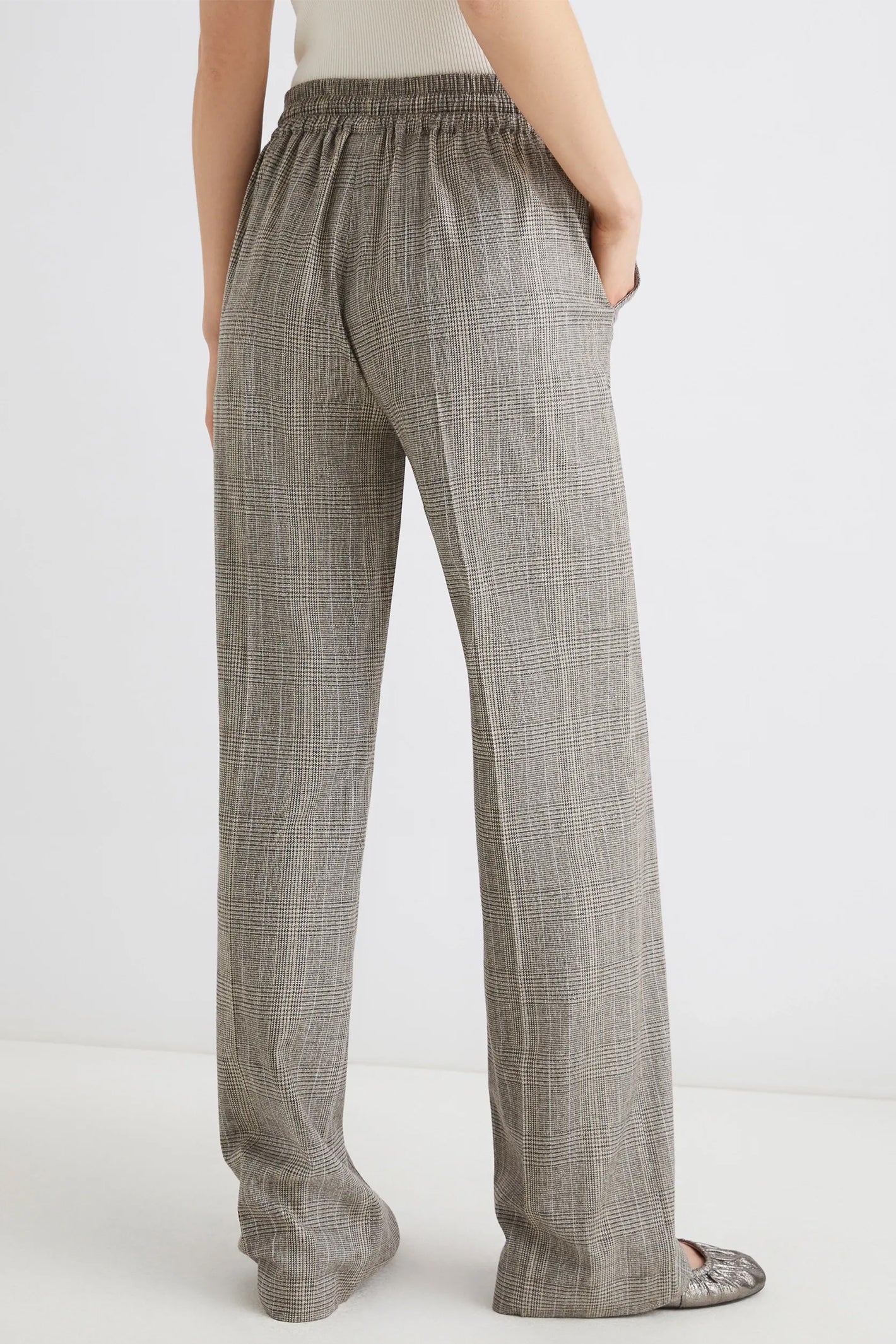 Plaid pants worn by a person on a white background