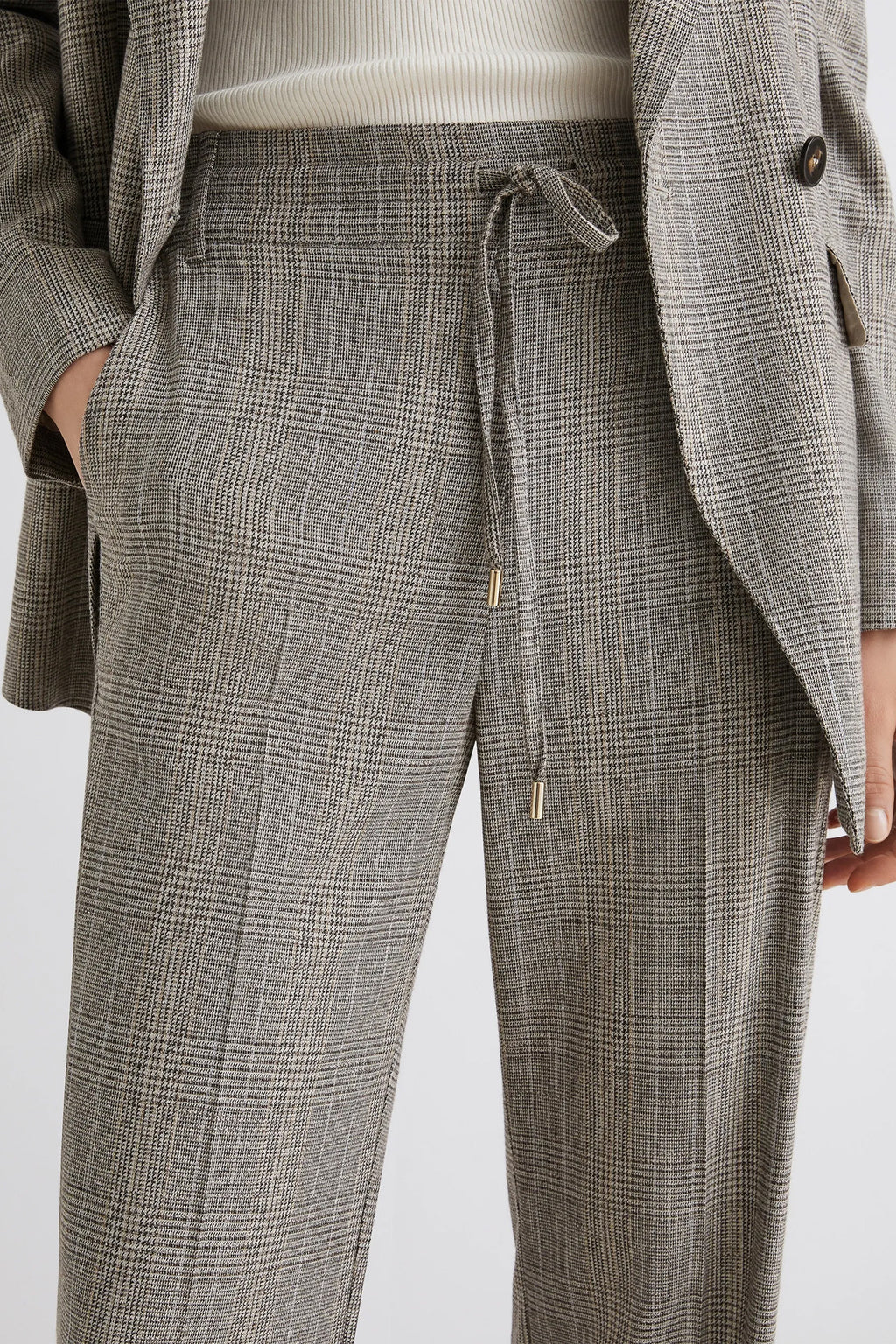 Gray checkered pants with a drawstring on a white background