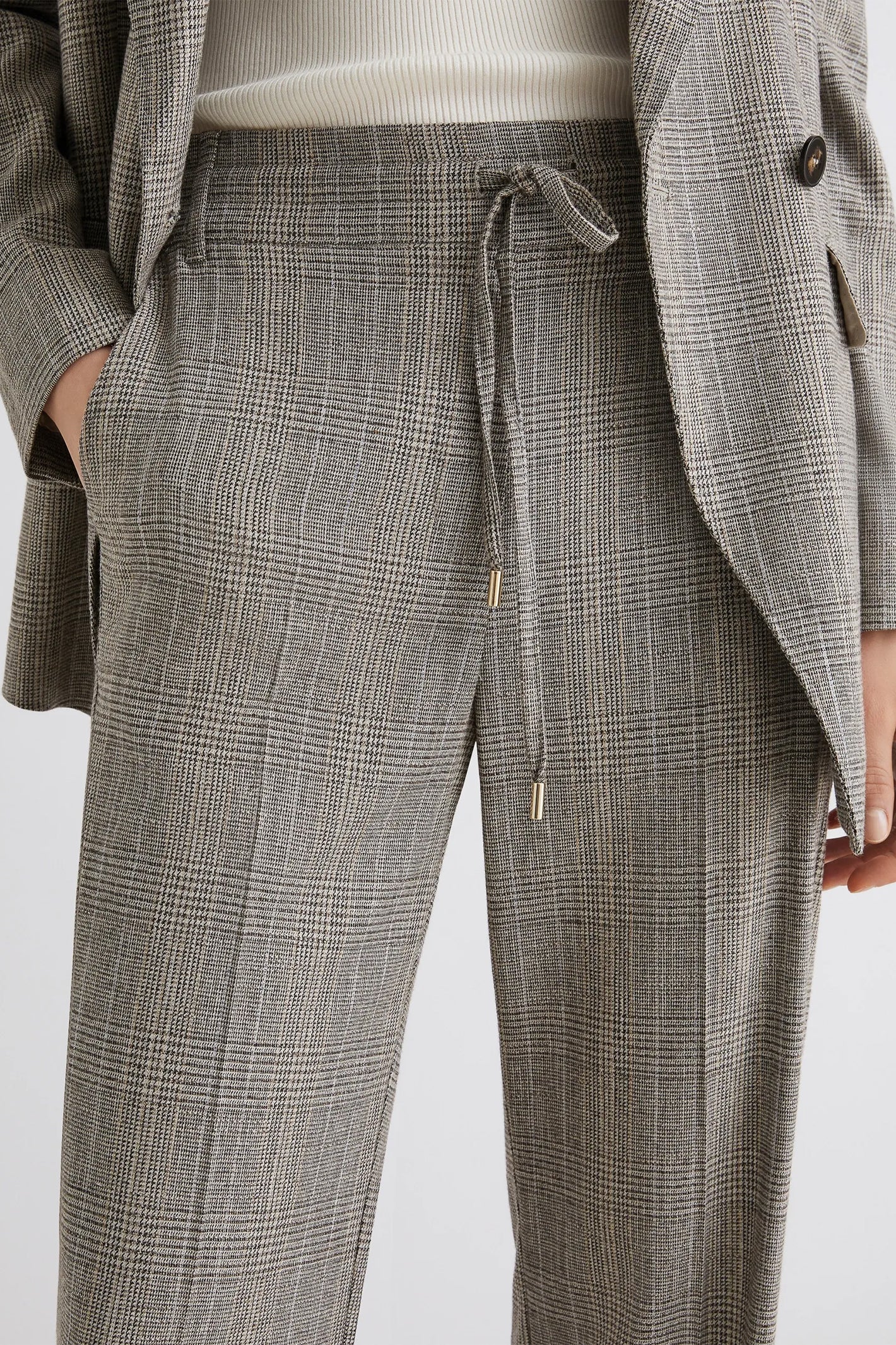 Gray checkered pants with a drawstring on a white background