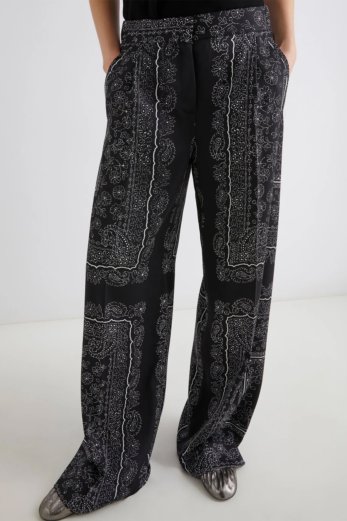 Black patterned pants on a white background