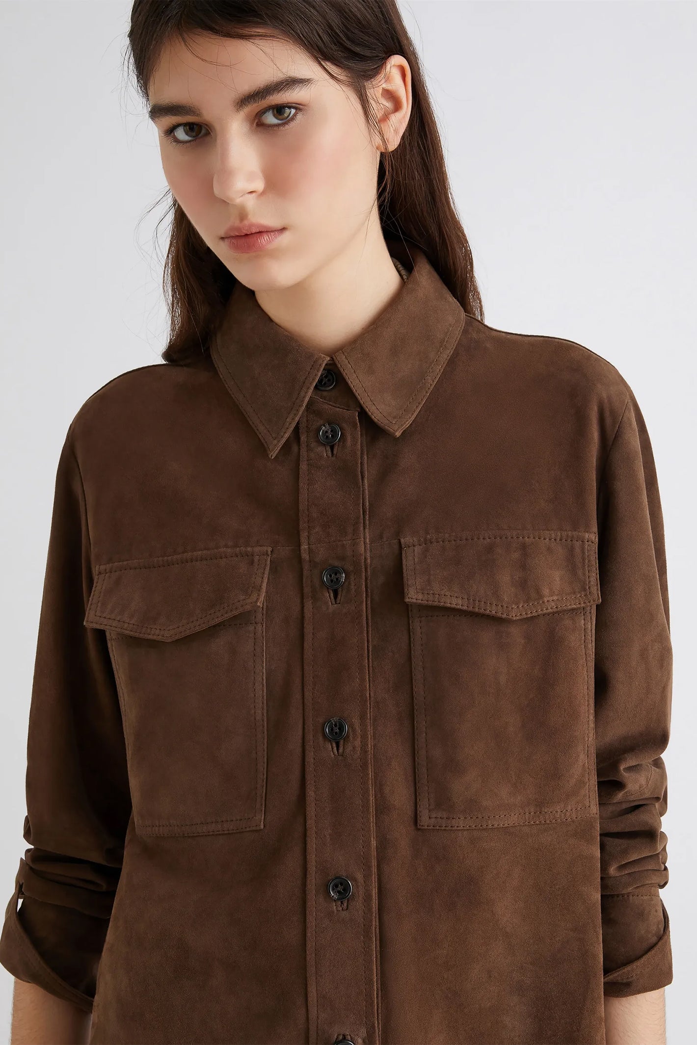 Brown suede jacket worn by a model on a white background