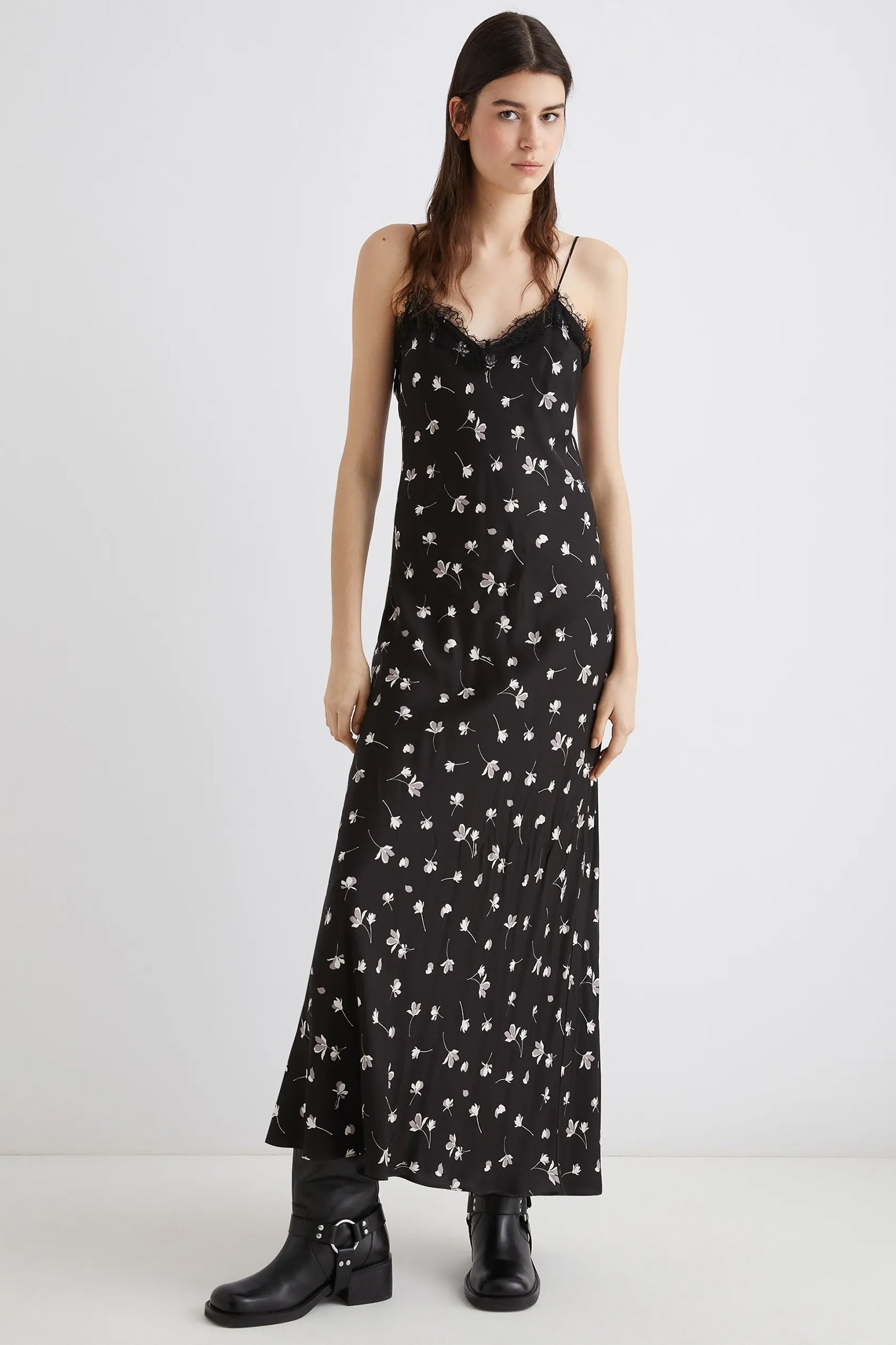 Woman wearing a black floral dress on a white background