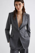 Woman wearing a gray suit with a white background