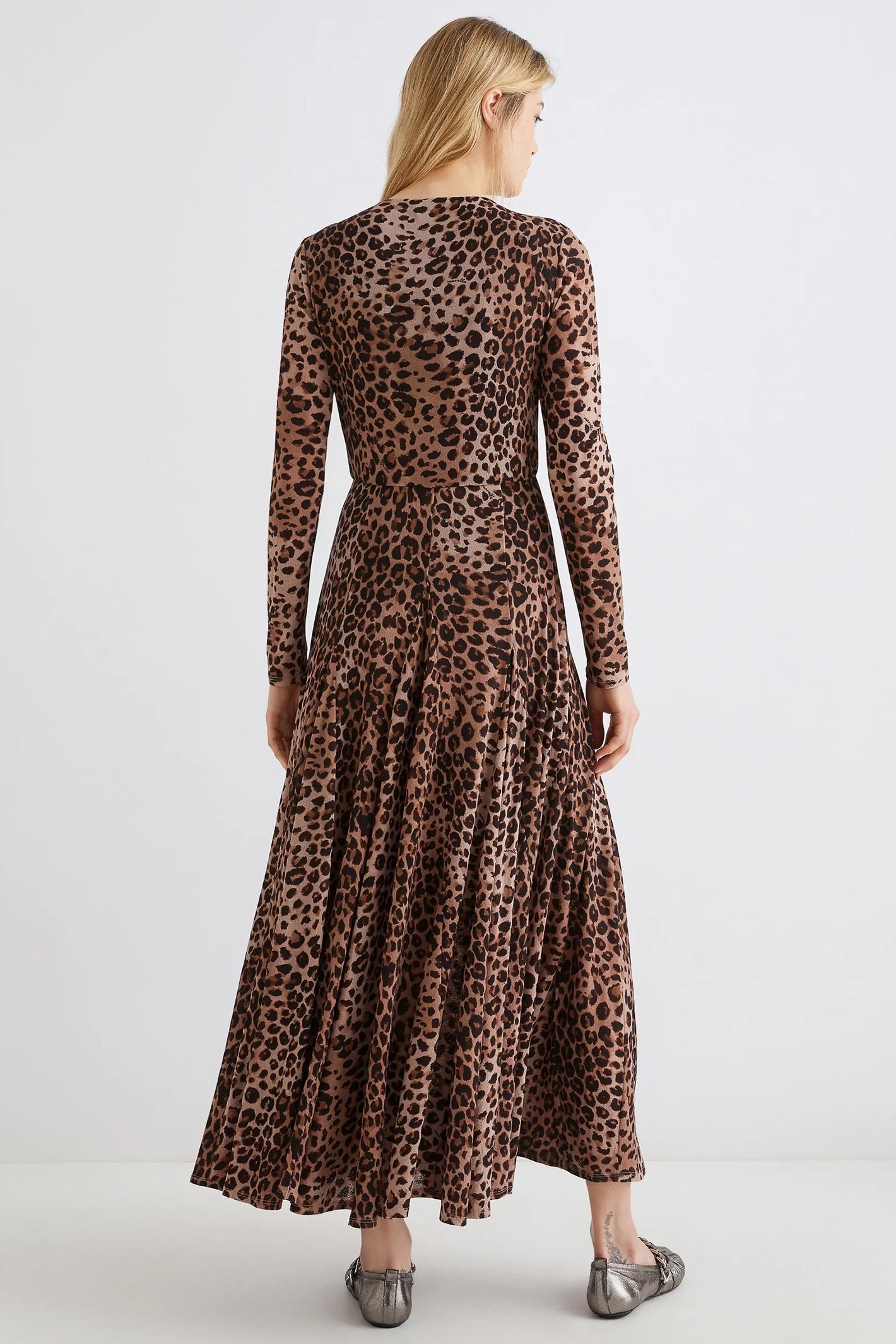 Woman wearing a leopard print dress on a white background