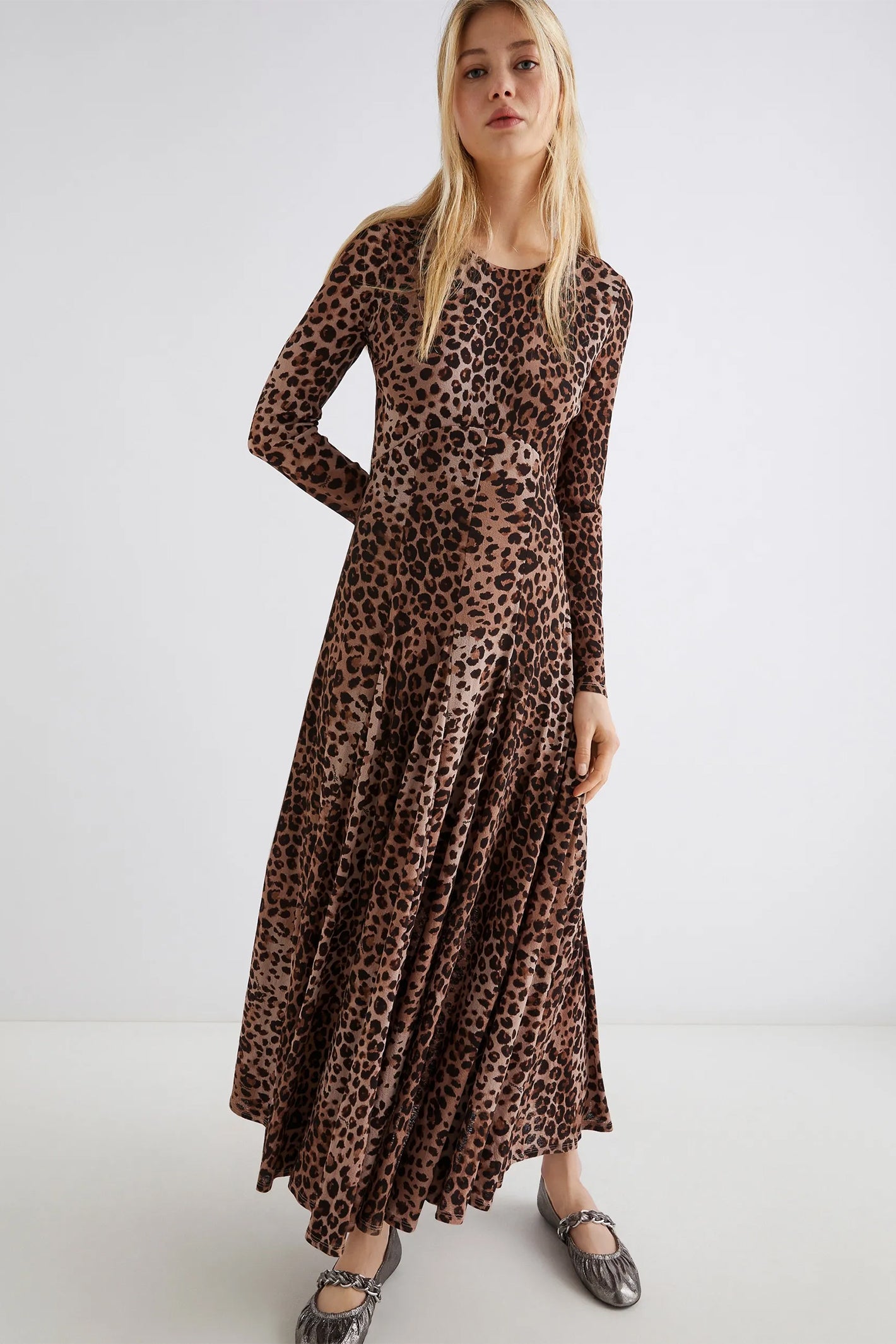 Woman wearing a leopard print dress on a white background