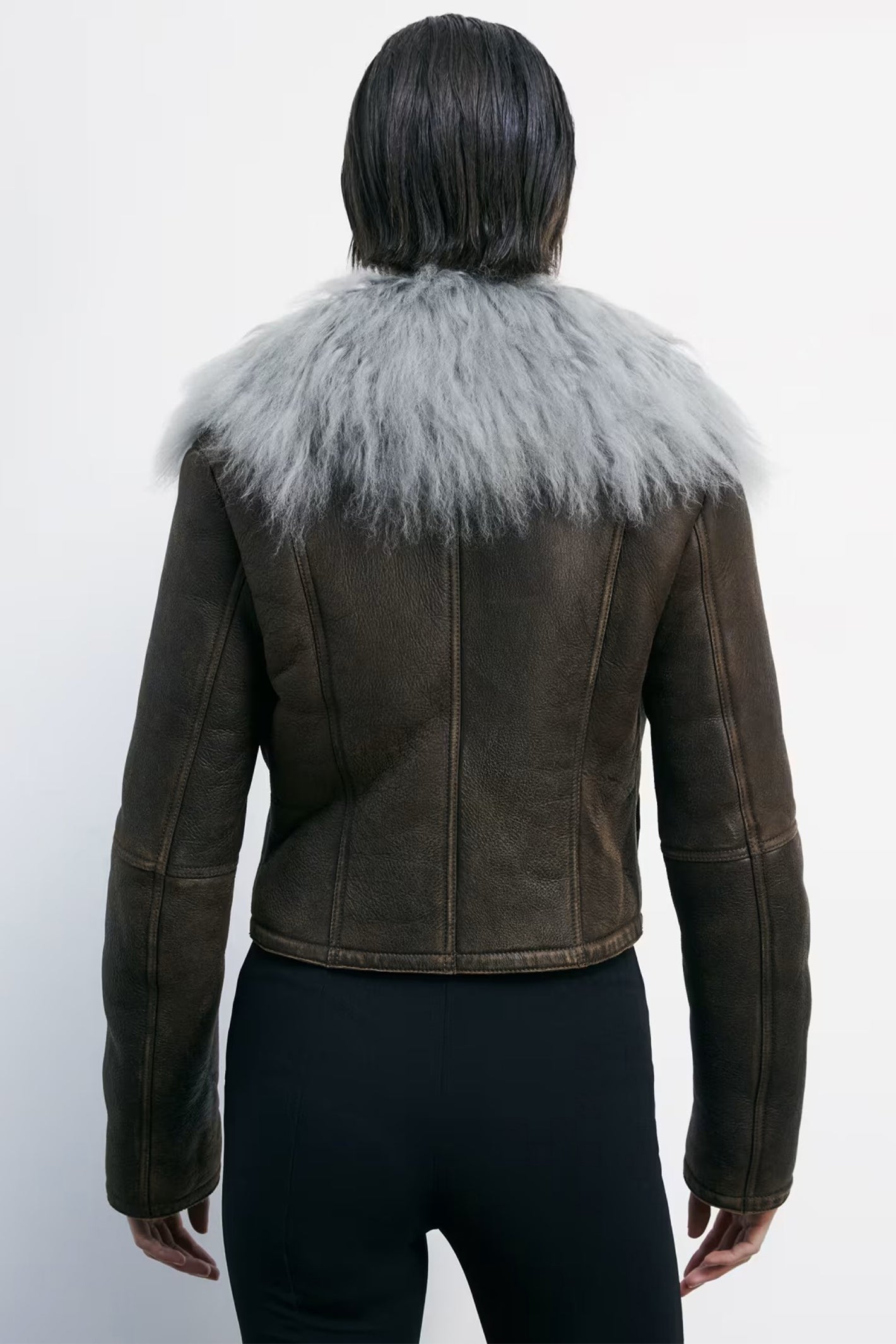 Brown leather jacket with gray fur collar on a white background