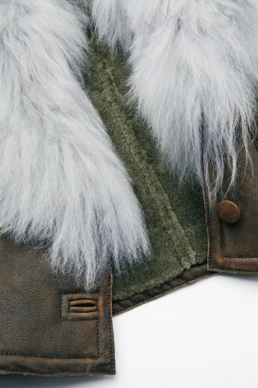 Close-up of a jacket with fur trim on a white background