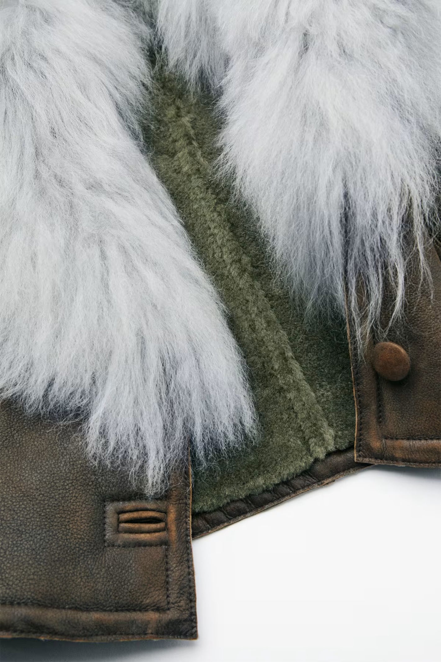 Close-up of a jacket with fur trim on a white background